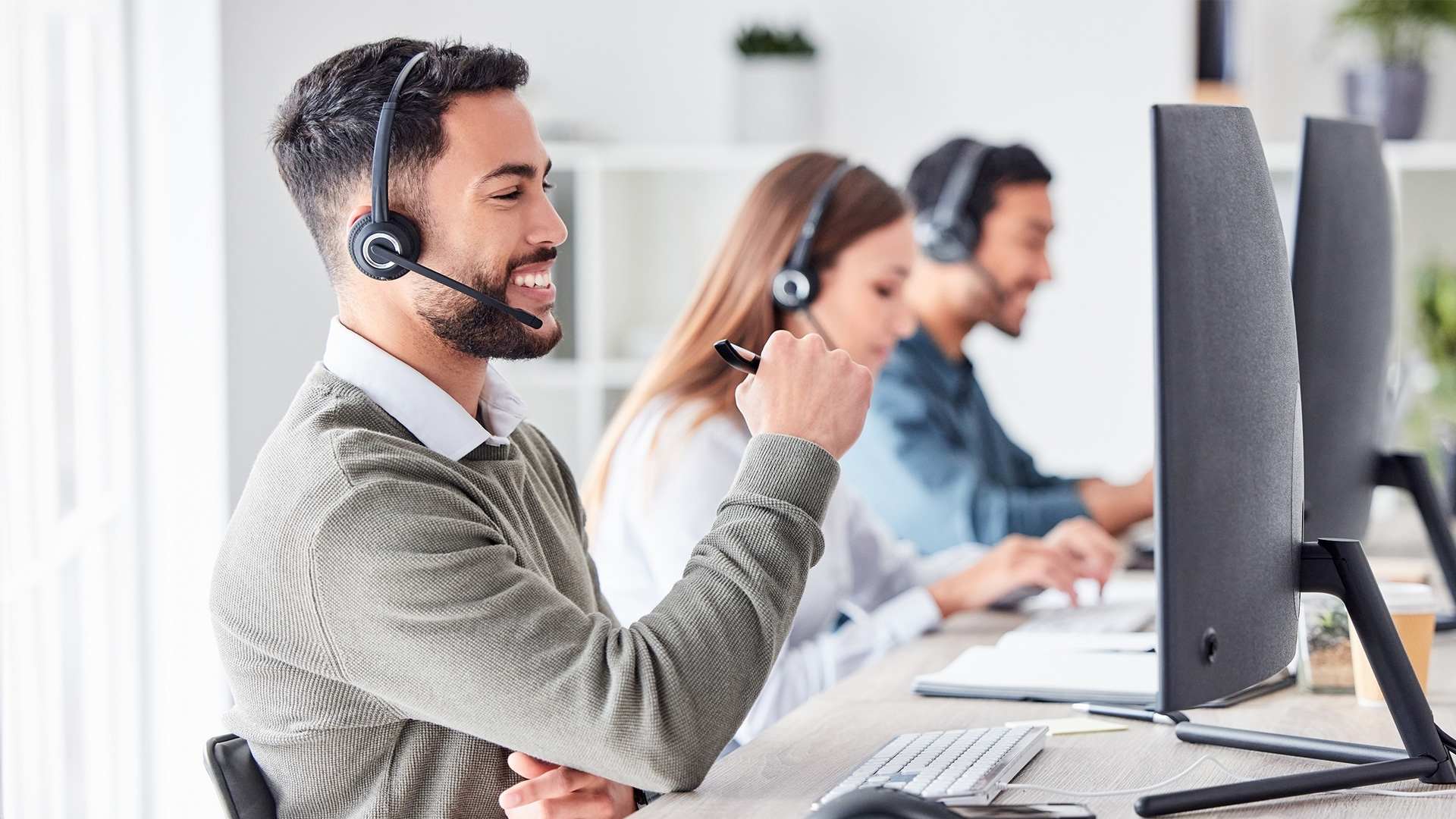 handsome-call-center-agent-helps-customer-with-a-smile